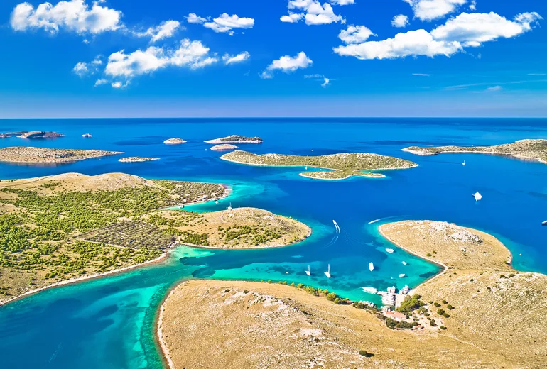 Aerial of the Kornati islands with turquoise lagoons and scattered anchored boats