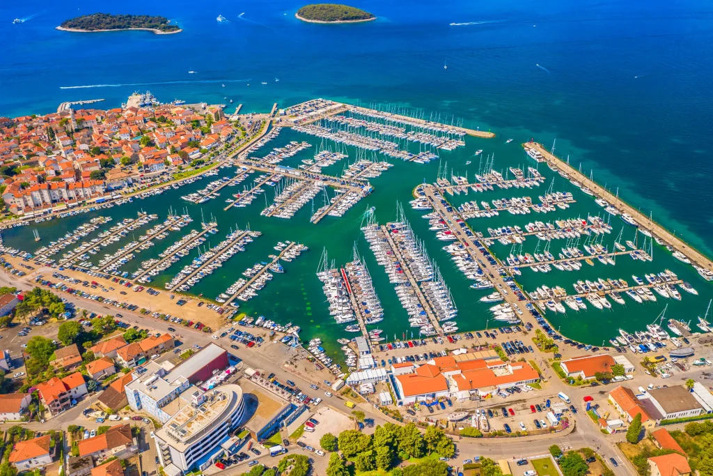 Aerial of Biograd na Moru town and marina packed with yachts, islands offshore