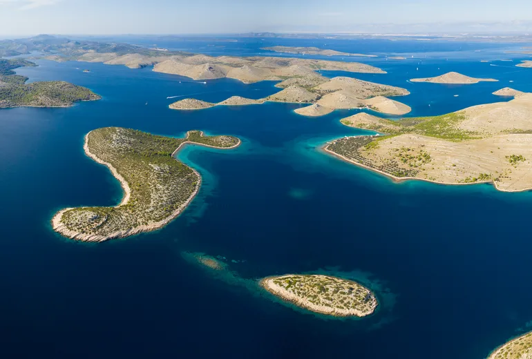 Sweeping aerial panorama of the bare Kornati archipelago islands and blue channels